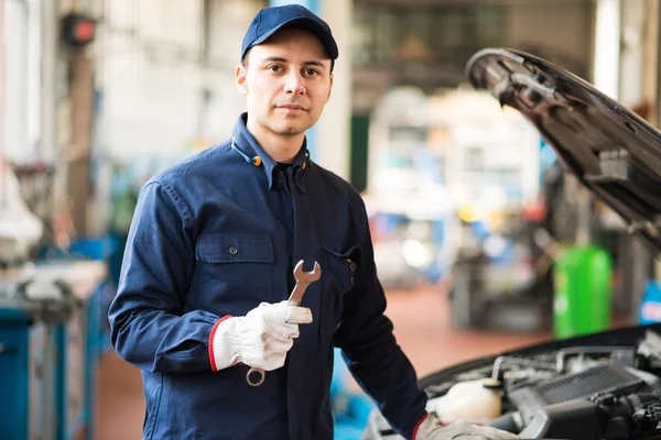 Mechanic holding a wrench — Stock Photo, Image