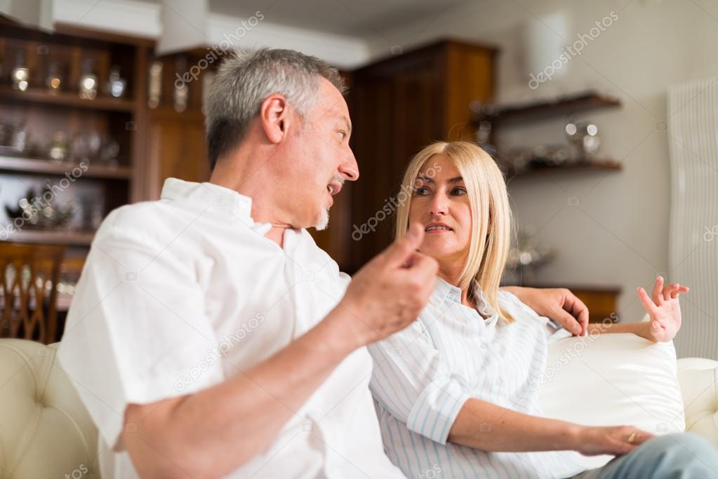 mature couple talking in their home