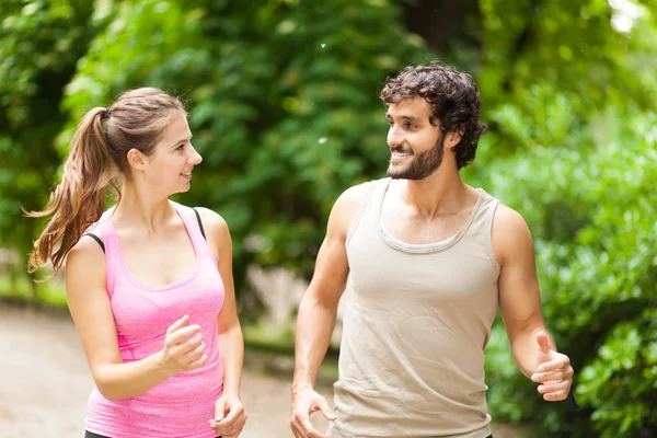 Couple running in a park — Stock Photo, Image