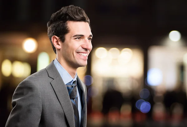 Businessman walking in city in night — Stock Photo, Image