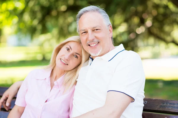 Happy couple sitting — Stock Photo, Image