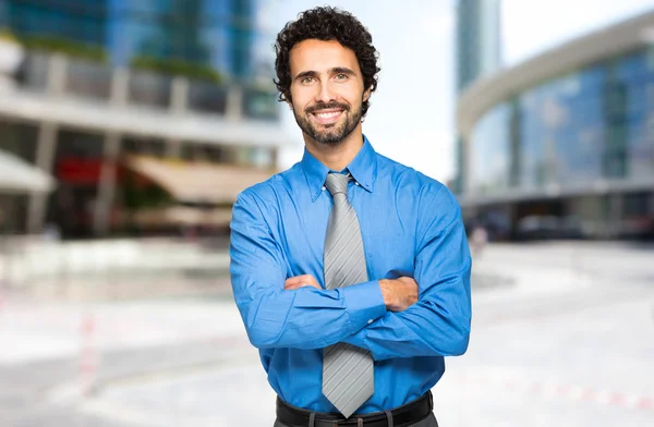 Businessman with crossed arms smiling — ストック写真