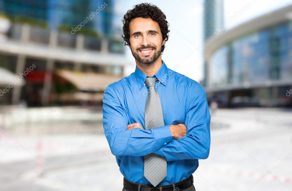 Businessman with crossed arms smiling