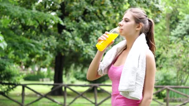 Woman drinking an energy drink after sport — Stock Video