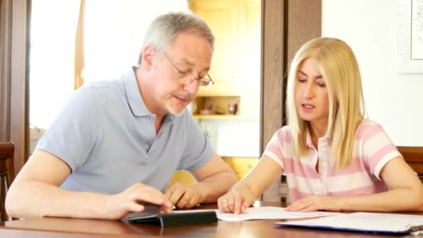Mature couple checking finances — Stock Video