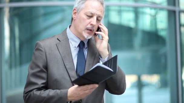 Hombre de negocios mayor hablando por teléfono — Vídeo de stock