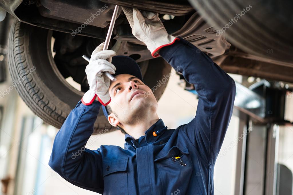 Mechanic repairing a lifted car