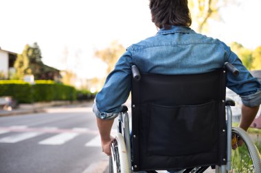 Disabled man preparing to go across road clipart