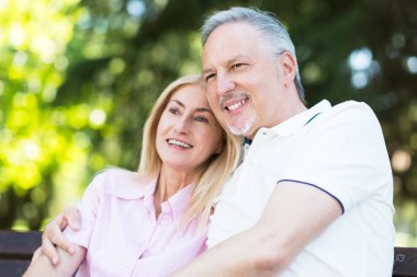 bir parkta oturan Olgun çift