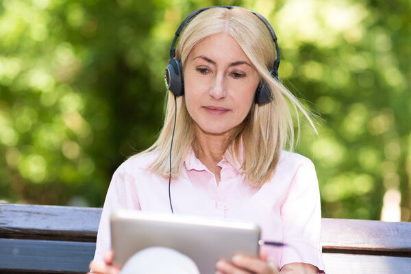 Mature woman listening music