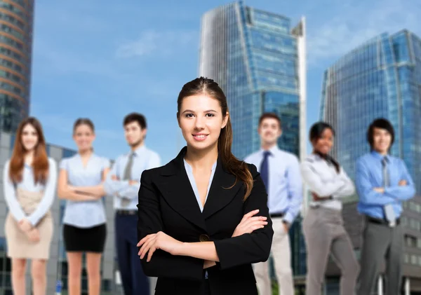 Businesswoman in front of business people — Stock Photo, Image
