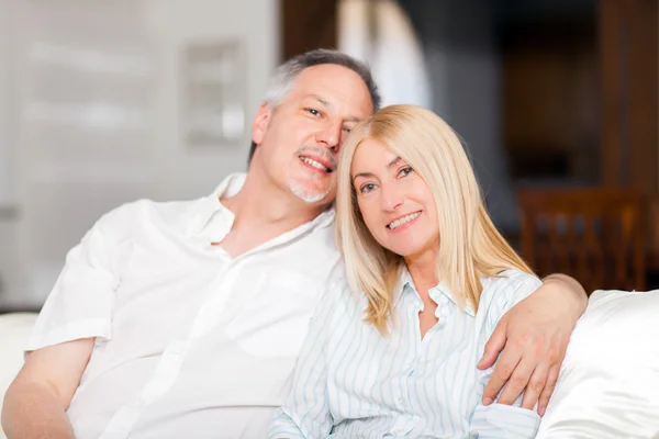 Mature couple sitting at home — Stock Photo, Image
