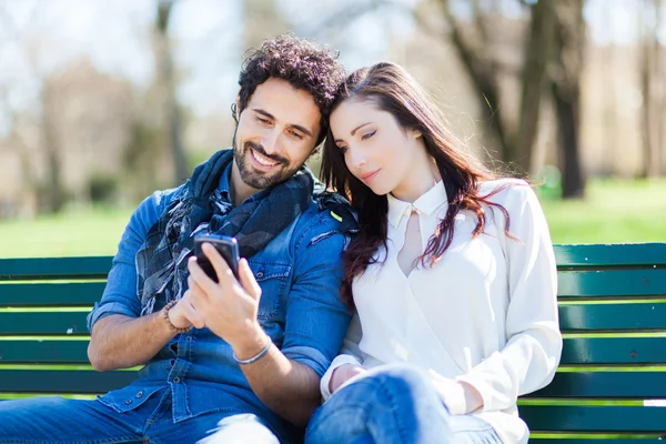 Hombre mostrando teléfono a mujer — Foto de Stock