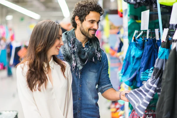 Couple shopping in dress shop — Stock Photo, Image