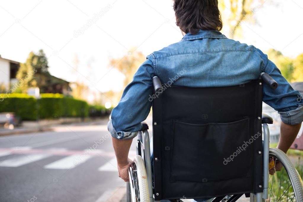 Disabled man preparing to go across road