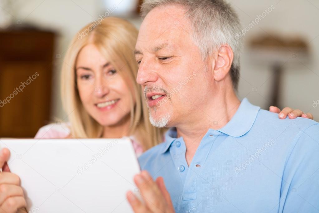 Mature couple using tablet