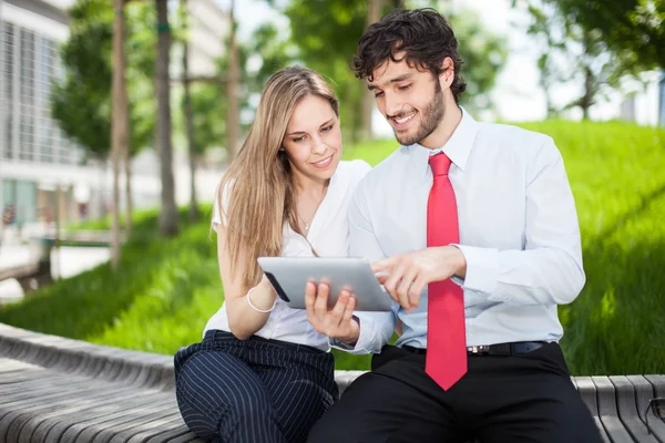 Couple of business people using tablet — Stock Photo, Image