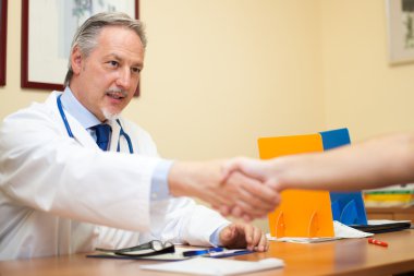 Doctor welcoming a patient clipart
