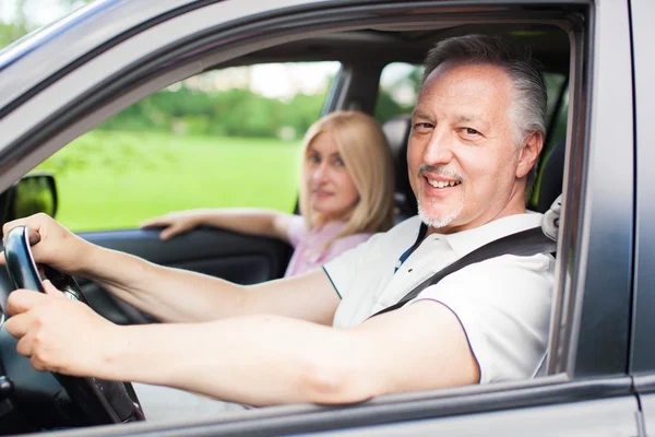 Mature couple traveling in car Stock Picture