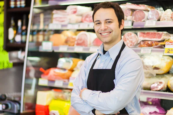 Tendero sonriente en la tienda de comestibles —  Fotos de Stock