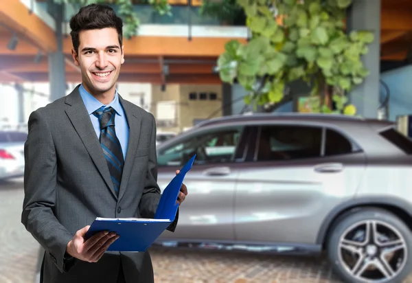 Handsome smiling car dealer — Stock Photo, Image