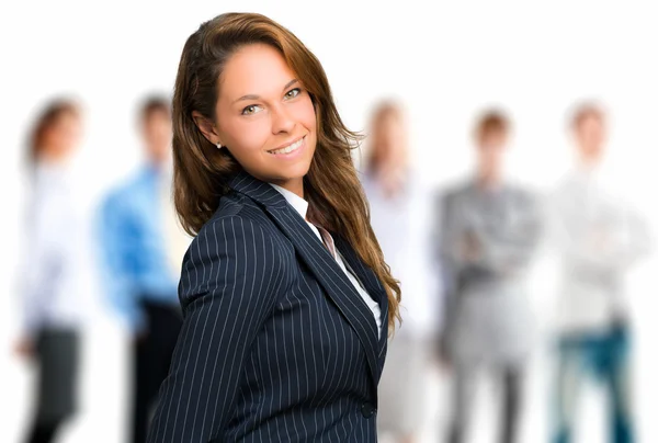 Businesswoman in front of her team — Stock Photo, Image