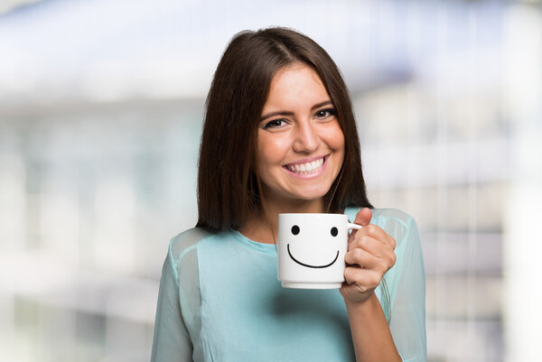 Smiling woman holding smiling cup