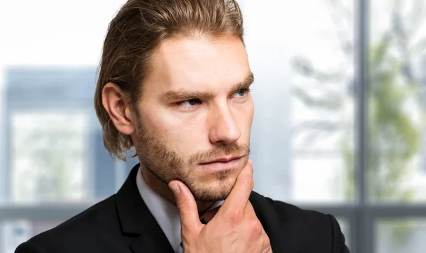 Businessman in pensive expression — Stock Photo, Image