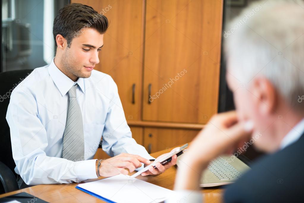 Businessman using his tablet