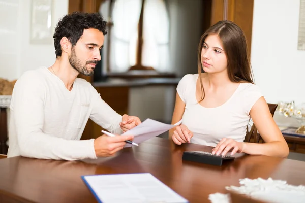 Couple calculating their expenses — Stock Photo, Image