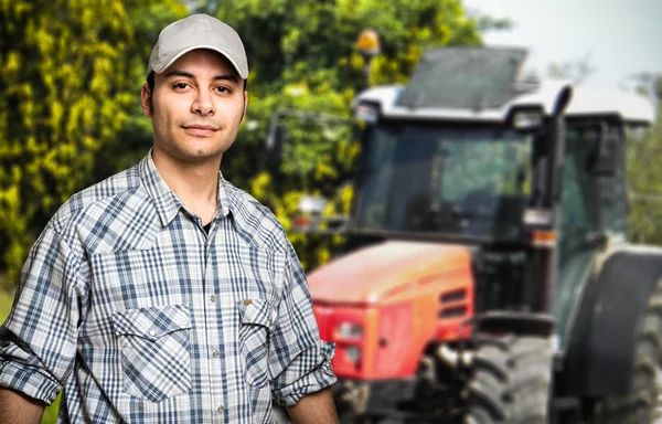 Agricultor na frente de seu trator — Fotografia de Stock