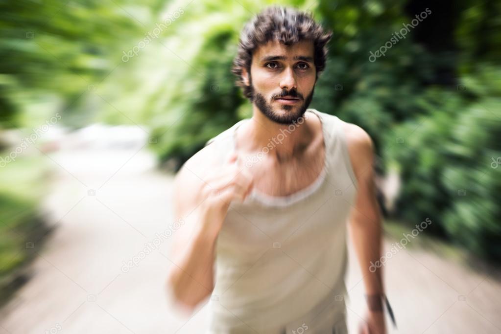 Man running fast in a park