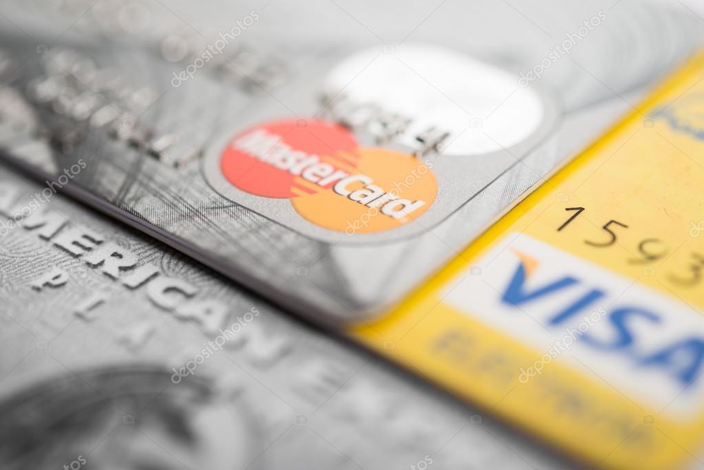 Vilnius, Lithuania - October 30, 2015: Closeup studio shot of credit and debit cards issued by American Express, VISA and MasterCard