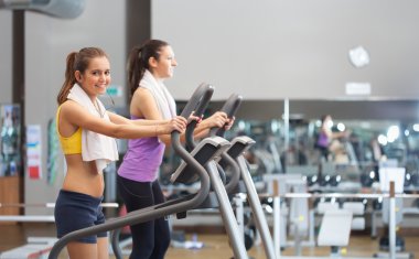 Bir spor salonunda çalıştırmak üzere bir koşu bandı kullanan kadın