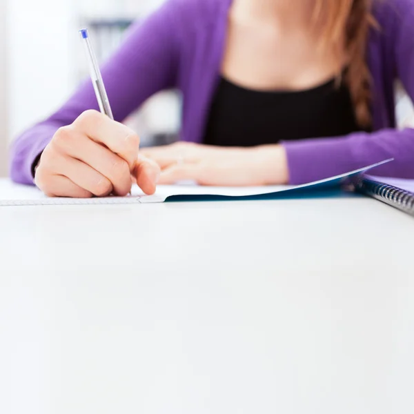 Student writing on notebook — Stock Photo, Image