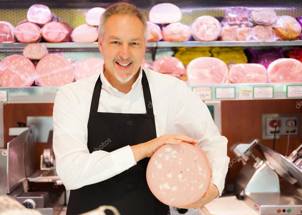 Shopkeeper showing italian bologna