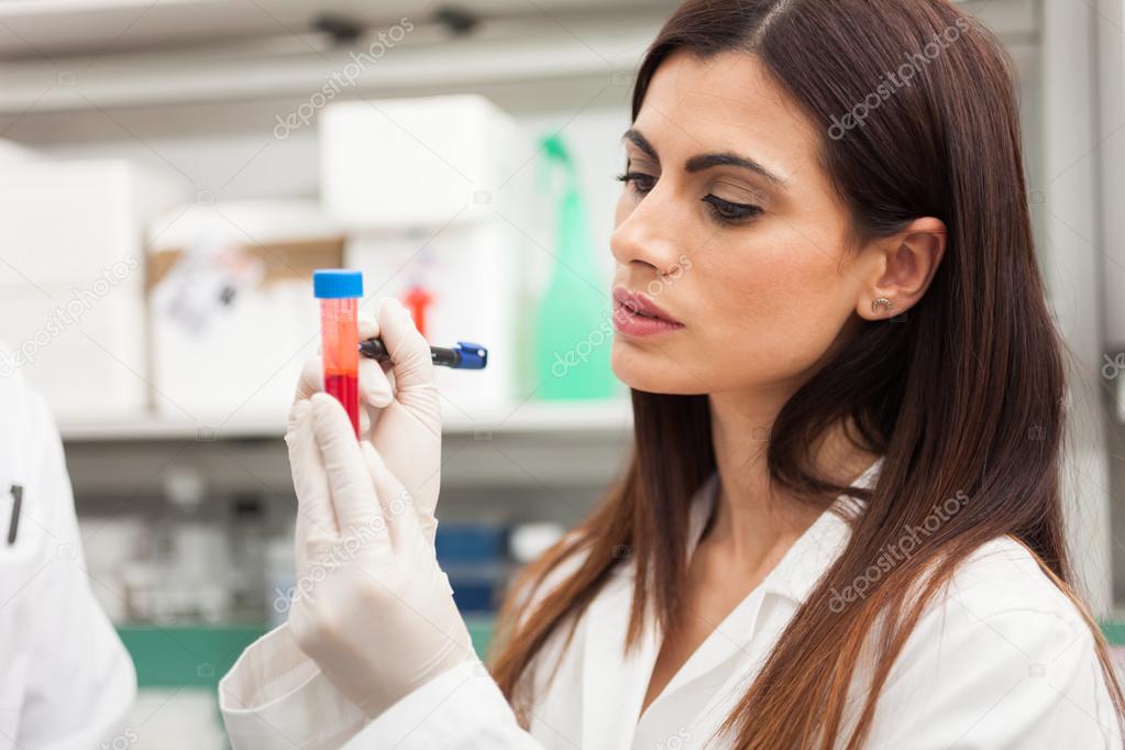 doctor writing on a blood sample