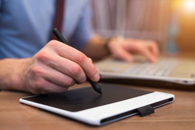 bir tablet kalem kullanarak adam