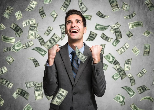 Man enjoying the rain of money — Stock Photo, Image