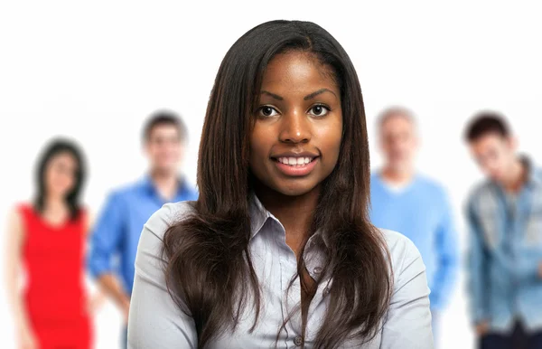 Smiling woman in front of a group of people — Stock Photo, Image