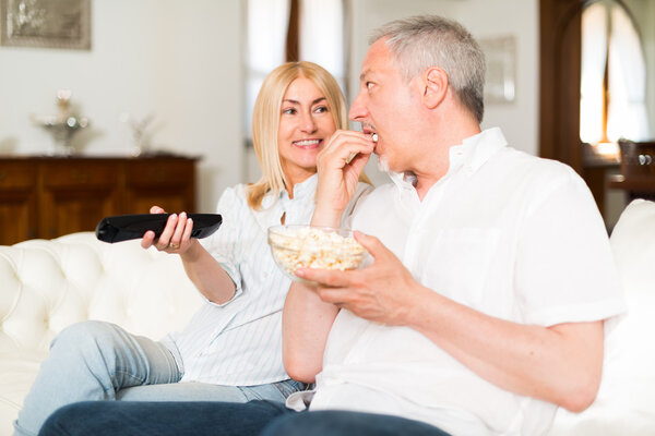 mature couple watching television