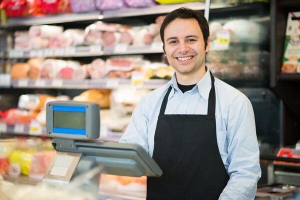 smiling shopkeeper in a grocery store