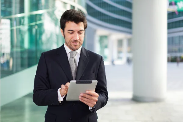 Businessman using his tablet Stock Image