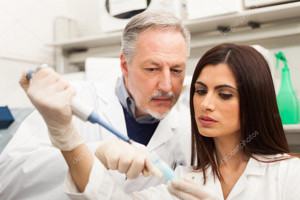 Scientist taking a sample from test tube