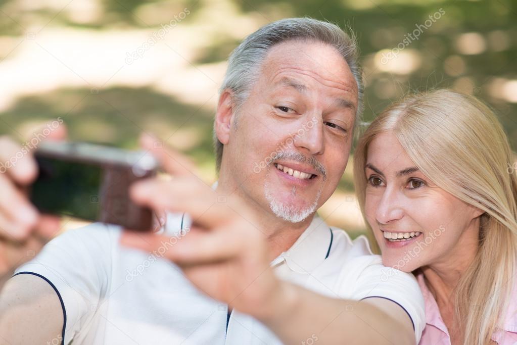 couple taking selfie in park