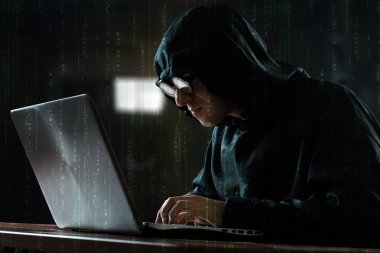 Hacker in front of computer clipart