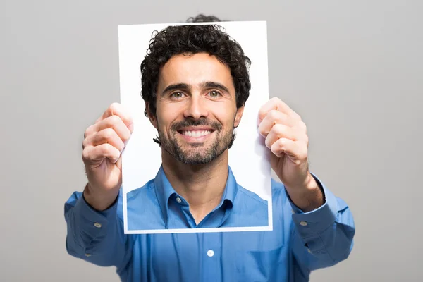 Man holding image of himself — Stock Photo, Image