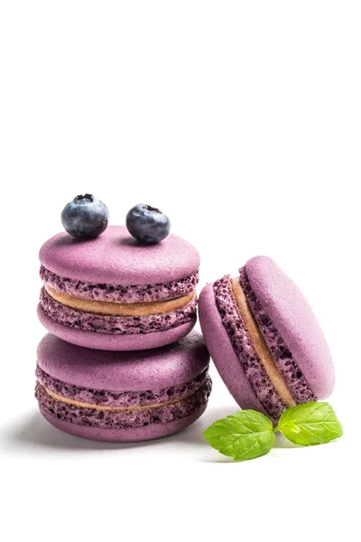 Fresh macaroons with blueberries on white background — Stock Photo, Image