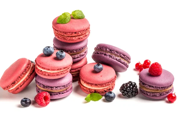 Delicious macaroons with berry fruits on white background — Stock Photo, Image
