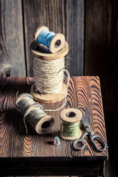 Sewing table with scissors and threads — Stock Photo, Image